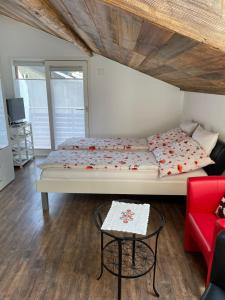 a bedroom with a large bed and a red couch at Haus Rosa in Zermatt +18 photos