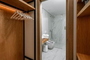 a bathroom with a shower and a toilet and a shower at Mary Hotel in Limenas +30 photos