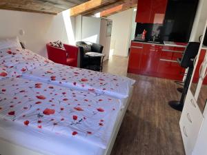 a bedroom with a bed with red flowers on it at Haus Rosa in Zermatt
