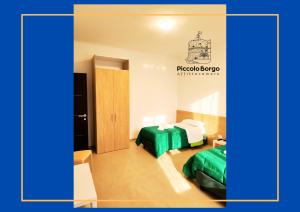 a hotel room with two beds and a door at Piccolo Borgo Affittacamere BIKE FRIENDLY in Taranto