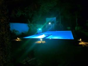 a swimming pool with lights in the dark at Karibu Paradaizi in Michamvi +141 photos