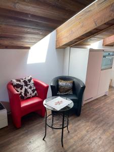 a living room with two chairs and a table at Haus Rosa in Zermatt