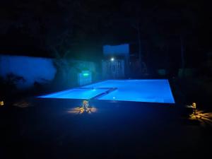 a large swimming pool lit up at night at Karibu Paradaizi in Michamvi
