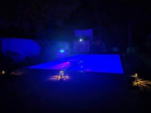an empty swimming pool at night with blue lights at Karibu Paradaizi in Michamvi