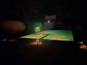 an empty tennis court at night with a green light at Karibu Paradaizi in Michamvi