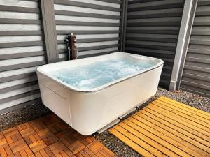 a bath tub sitting on the side of a house at tocoro. Mt. Fuji Mutsuki in Fujikawaguchiko