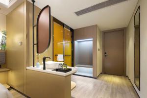 a bathroom with a sink and a mirror at mango crystal hotel in Haikou +98 photos