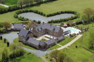 an aerial view of a large house with a pool at Domaine De Kermodest in Quemper-Guézennec