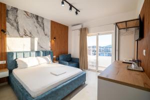 a bedroom with a bed and a desk and a window at Vila Naço Ksamil in Ksamil +128 photos