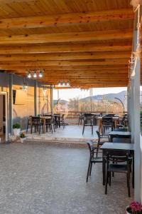 a group of tables and chairs on a patio at Vila Naço Ksamil in Ksamil