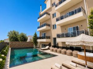 a villa with a swimming pool in front of a building at Hotel Mare in Ksamil