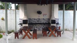 a group of tables and chairs under a pavilion at Ubatuba Casa Condomínio Sans Souci 707-14 in Ubatuba