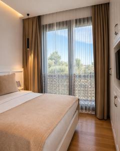 a bedroom with a bed and a large window at Cunda EYE in Cunda +54 photos