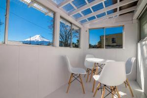 a room with white chairs and a view of a mountain at tocoro. Mt. Fuji Hazuki in Fujikawaguchiko