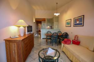 a living room with a couch and a table at Sporting Hotel in Cannigione