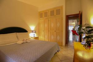 a bedroom with a bed with a pink bow on it at Sporting Hotel in Cannigione