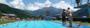 a large swimming pool with people in a resort at Landart-Appartements in Virgen