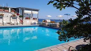 a swimming pool with a view of the ocean at Hotel Bianca Maria in Varazze