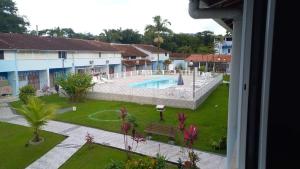 a view of the pool from the balcony of a resort at Ubatuba Casa Condomínio Sans Souci 707-14 in Ubatuba