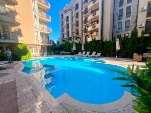 a large swimming pool in the middle of a building at Dawn Park Deluxe 3 floor in Sunny Beach