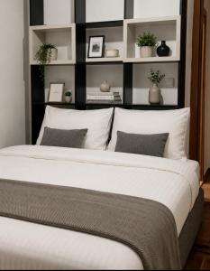 a bedroom with a large bed with white pillows at Budva apartman Haustor in Budva
