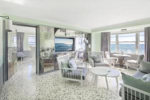 a living room with a couch and a table at COMO Metropolitan Miami Beach in Miami Beach