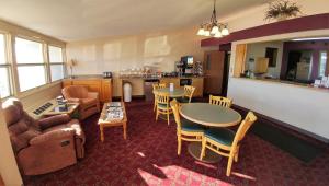 a living room with a couch and a table and chairs at Red Carpet Inn - Windom in Windom