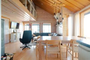 a kitchen and dining room with a table and chairs at Villa Alli in Siikainen