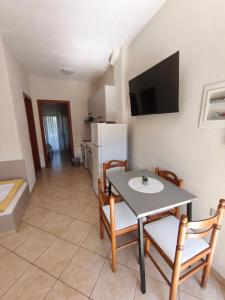 a kitchen and dining room with a table and chairs at Kiparissis Apartments in Kriopigi