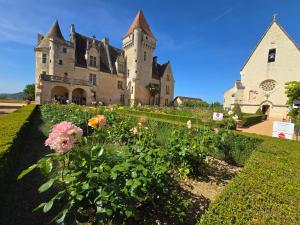an old castle with flowers in front of it at Les Pierres Du Périgord 200 in Couze-et-Saint-Front