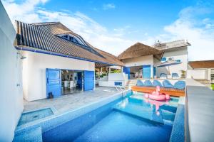 a villa with a pool and a pink rubber duck in the swimming pool at Bali Bio Villas in Uluwatu
