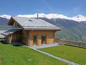 a small wooden house with mountains in the background at Charming Private Bungalow in Wohlenberg on Natural Beach in Hérémence