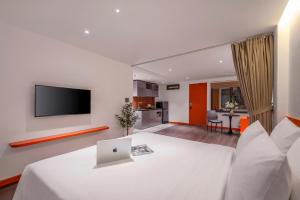 a room with a bed with a laptop on it at The Locals Hotel - Dinh Thi Hoa Da Nang in Danang