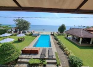 a swimming pool in the middle of a yard at Cozzy Seaview Beach Resort in Jepara