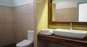 a bathroom with a sink and a toilet and a mirror at Cozzy Seaview Beach Resort in Jepara +17 photos