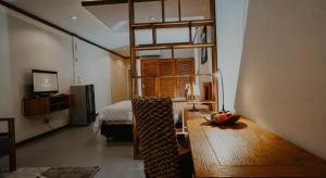 a room with a table and a bed and a room with a loft bed at Cozzy Seaview Beach Resort in Jepara