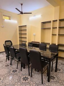a conference room with a table and chairs at Villa Yogalakshmi in Chidambaram
