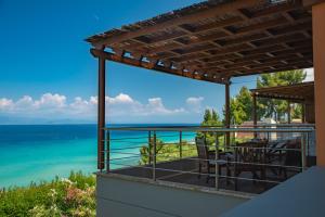 a view of the ocean from the balcony of a house at The Quite Blue villa in Kriopigi