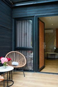 a patio with a chair and a table and a window at Blue Heaven Seaside in Borsh