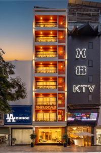 a building with a sign on the side of it at The Locals Hotel - Dinh Thi Hoa Da Nang in Danang