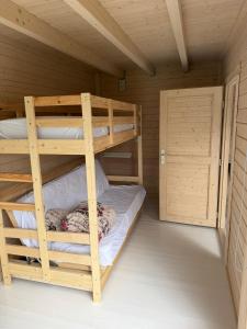 a room with two bunk beds in a cabin at Teemeistri Camp in Tõrva