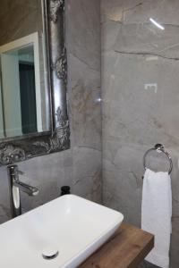 a bathroom with a white sink and a mirror at Holiday House Vego in Čapljina +15 photos