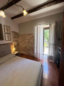 a bedroom with a large bed and a window at Asparano in Ognina