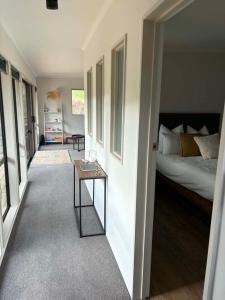 a bedroom with a bed and a table in a room at Clydesvale Apartment in Clyde