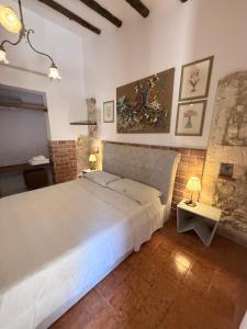 a bedroom with a large white bed in a room at Asparano in Ognina