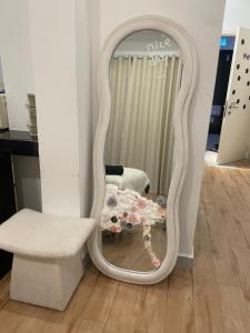 a mirror in a room with a bench and a chair at Amin Studio Apartment Pool And Netflix in Gua Musang