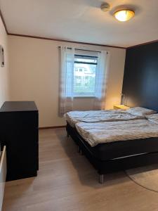 a bedroom with a large bed and a window at Rent Apartament Lofoten in Svolvær