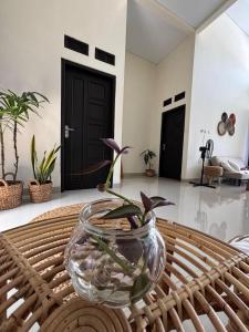 a glass bowl on a table with a plant in it at Secretspot Yogyakarta in Yogyakarta