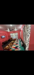 a room with red walls and a colorful carpet at Derban guest house in Srinagar +1 photo