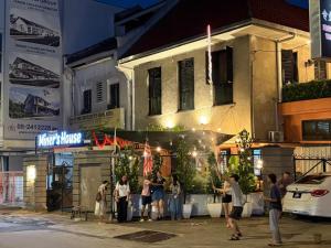 a group of people standing outside of a building at Miner's House Ipoh in Ipoh